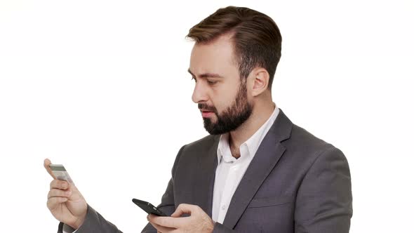 Portrait of Successful Bearded Businessman Wearing Mustaches Paying with Credit Card While Making