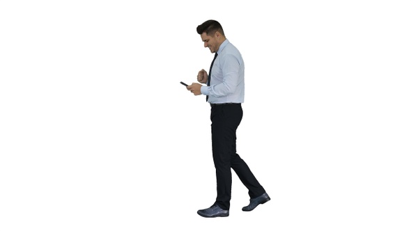 Man walking looking on phone and making win gesture on