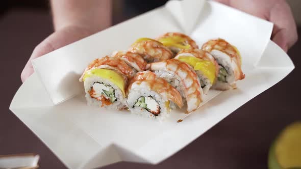 Shrimp sushi with sauce, in a cardboard box