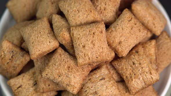 Crispy chocolate pads rotation in bowl. Cocoa cereal dessert for a fast breakfast. Morning