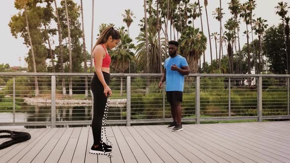 Woman working out with a trainer in the park