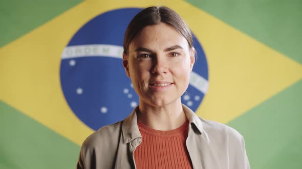 Portrait of Cheerful Brazilian Woman on National Flag