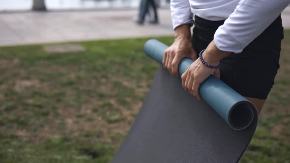 Girl Rolls Up Yoga Mat