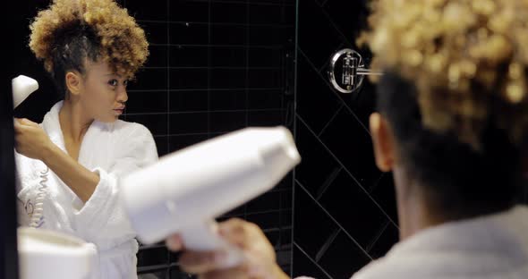 Charming Girl in Bathroom Using Hairdryer