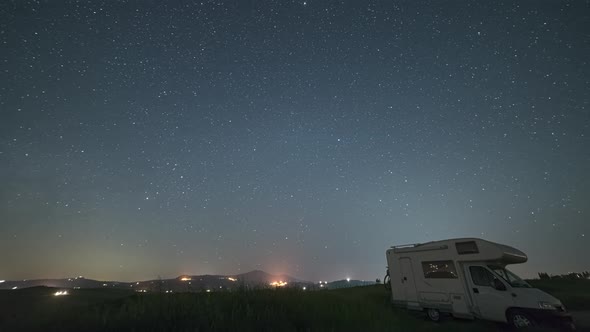 Time lapse: night sky landscape in Orcia Valley, Tuscany, Italy. The Milky Way galaxy and stars over