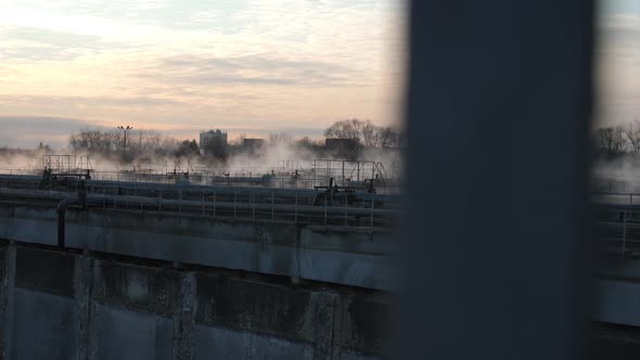 Steam Rising Over Basins at Waste Water Treatment Station