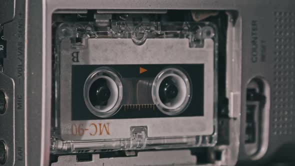 Audio Cassette in the Tape Recorder Playing and Rotates