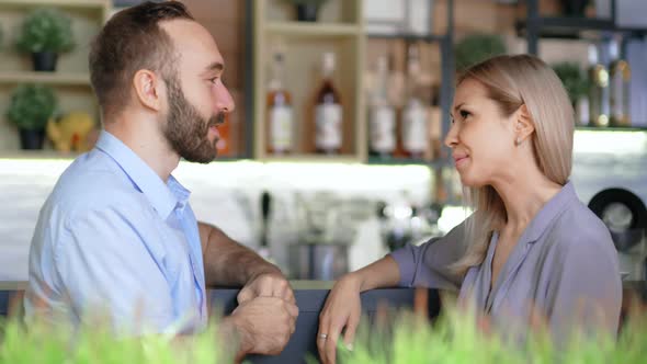 Two European Friends Having Break in Cafe Discussing and Gossiping Side View