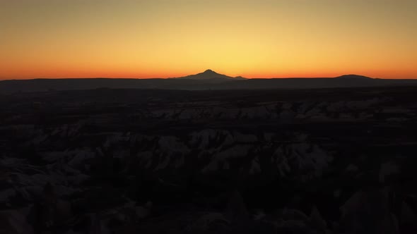 Amazing Golden Sky Illuminated By the Sun Hiding Behind Mountain Ridge Filmed By Drone