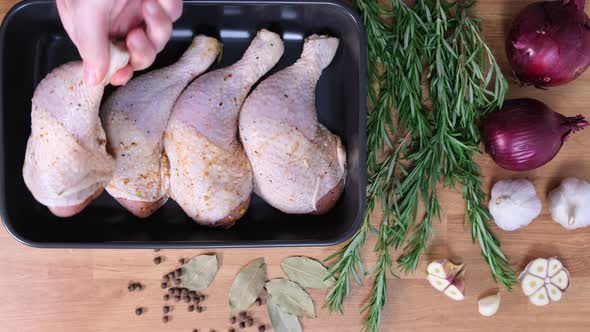 Chicken legs in baking dish. Cooking baked chicken