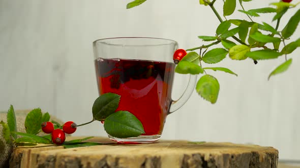 Tincture Of Herbs And Red Berries, Tea From Medicinal Rose Hips On A Wooden Background, Homeopathy