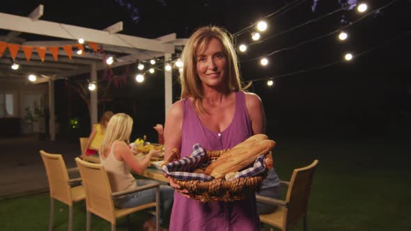 Senior woman holding food basket outdoors