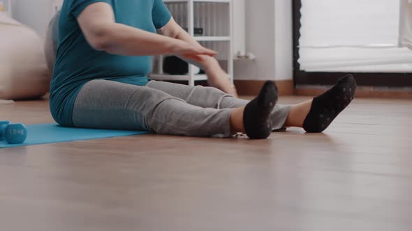 Close Up of Pensioner Doing Physical Exercise to Stretch Muscles