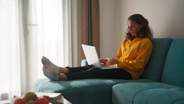 Young Woman Working the Home and Coughs.