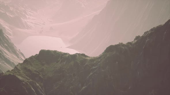 Rocks Covered with Grass Under a Cloudy Sky