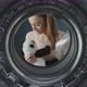 Woman washing a cute plush in the washing machine - VideoHive Item for Sale