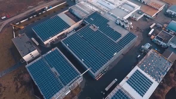 Huge solar farm on rooftop of buildings. Photovoltaic solar panels receive ecological energy from th