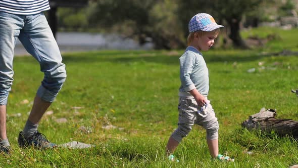 Father and Son Walk By the Hands in the Open Air. Concept of Trust and Love. Parent Walks in Nature