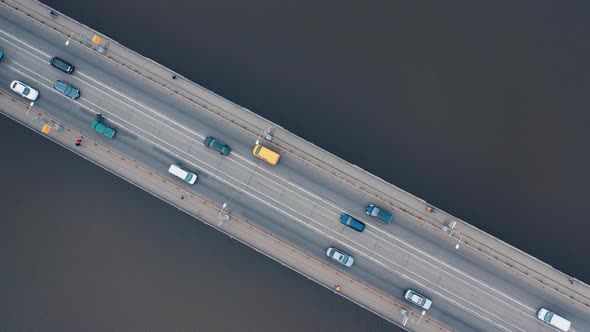 Urban car traffic on the bridge over the river.