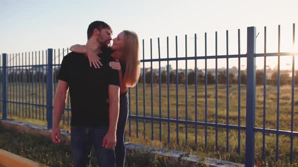 An Attractive Couple in Love Embrace and Enjoy an Intimate Moment Together Against the Sunset or