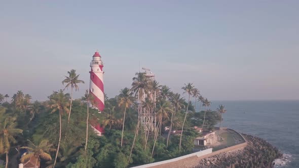 Thangassery Lighthouse at sunset in Kerala, India. Aerial drone view