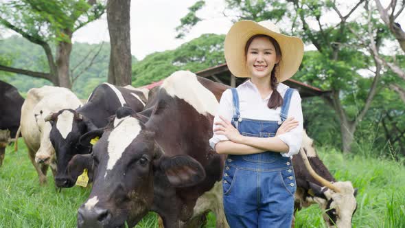 Portrait of Attractive Asian dairy farmer woman work outdoor in farm.