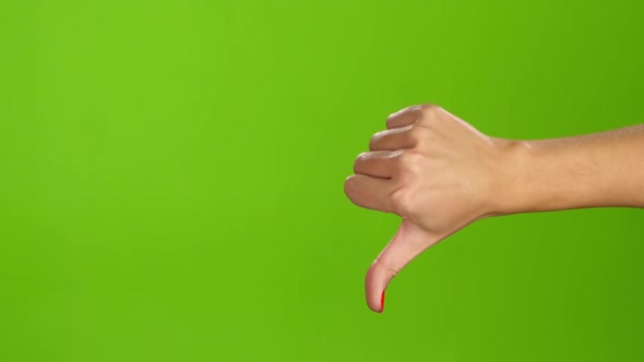 Sign Language. Thumbs Down Female Hand on Green Screen Background