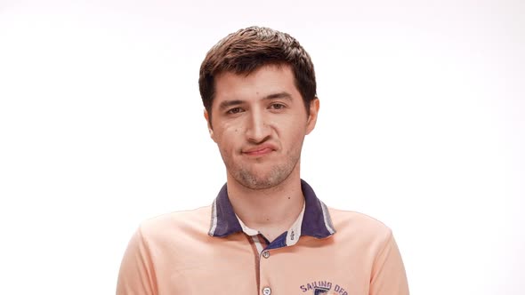 Displeased Young Man Thinking Over White Background Slow Motion