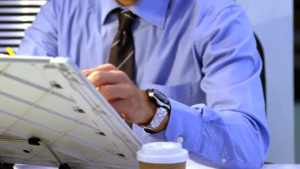 Businessman writing on whiteboard