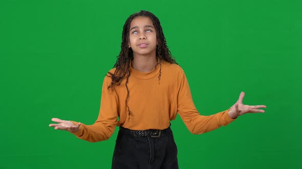 Portrait of Irritated Disappointed Teenager Gesturing at Chromakey Background