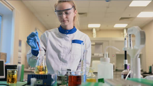 Woman Chemist is Working with Drug and Reagents at Table in Pharmaceutical Laboratory Spbas