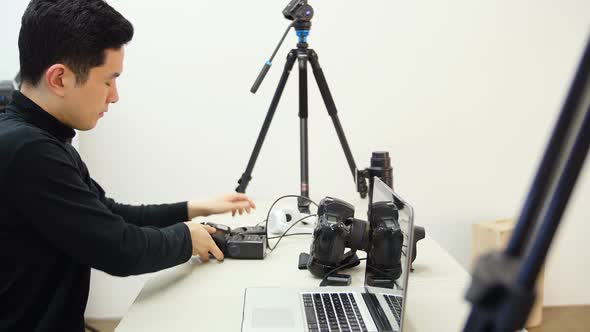 Male photographer working at desk