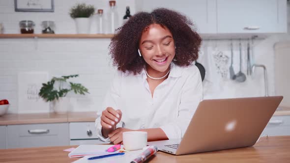 Young African American Woman Waving and Greeting Someone During Video Call