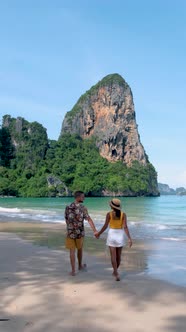 Railay Beach Krabi Thailand Asian Women and European Men Walking on the Ebach in the Morning