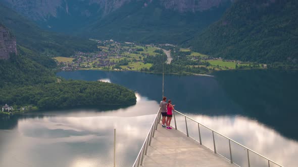 GIMBAL TRACKING TILT UP, An athletic sporty couple look at the dramatic view