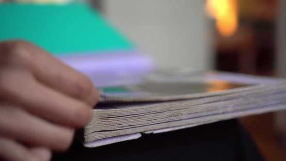 Woman is Looking at Old Photo Album at Home