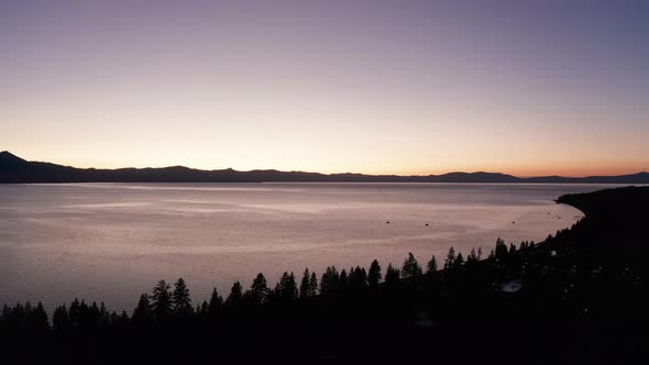 Wide aerial shot of the Lake Tahoe shoreline at twilight. 4K