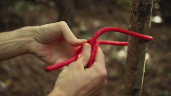 Man Ties a Safety Rope Around the Harness Before Top Rope Climbing