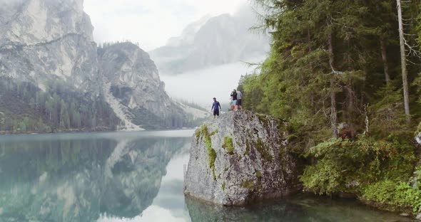 Aerial Drone Flight Over Group of Friends People Looking at Lake