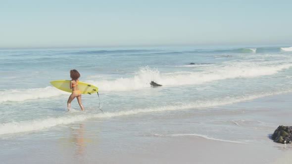 African American woman ready to go surf