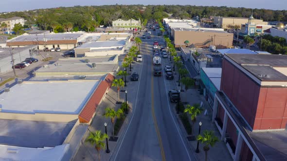 Flying Over Cars and Shops on the Main Road of a Small Town in Florida