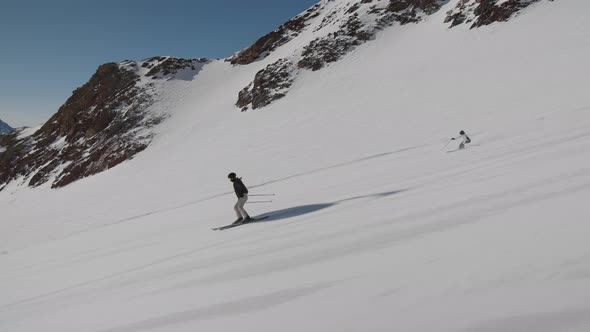 Woman Skiing Quickly Down Mountain Ski Slope