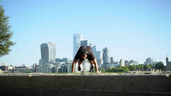 Slow motion shot of man doing push-up in city