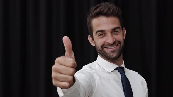 Businessman Turning With Thumbs Up