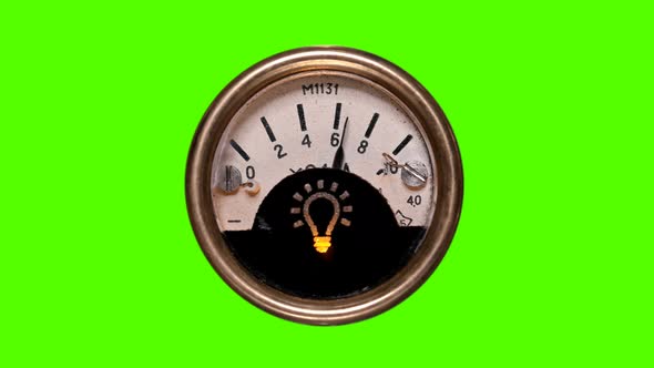 A Round, Vintage Gauge Voltmeter, on Which an Arrow Randomly Jumps, Showing Voltage, on a Green