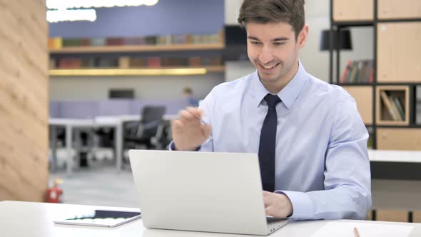 Businessman Talking on Phone at Work