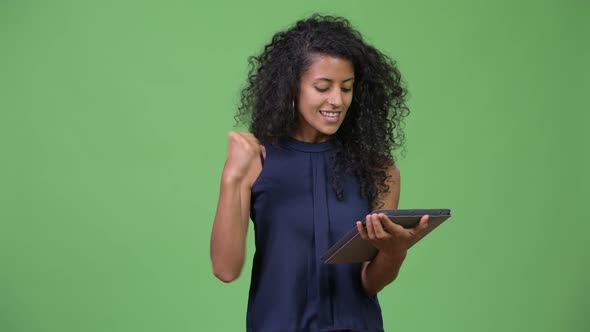 Young Beautiful Hispanic Businesswoman Using Digital Tablet