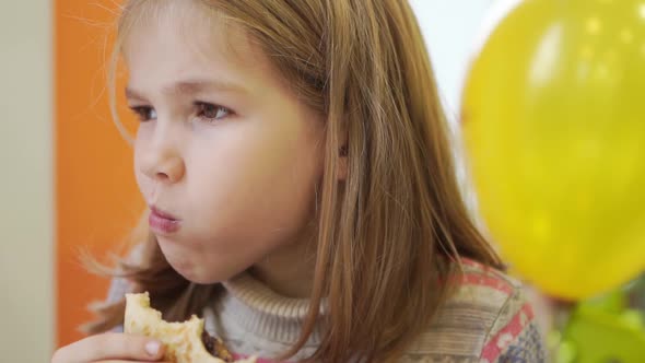 a Kid Girl Eats a Stuffed Pancake in a Cafe