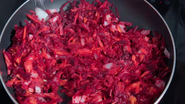 Cook Mixes Chopped Onion Grated Beetroot and Tomatoes in Pan