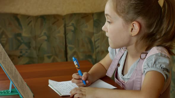 A Cute Little Girl is Doing Her Homework